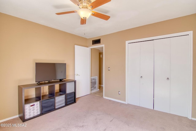 unfurnished bedroom featuring carpet flooring, a closet, ceiling fan, and visible vents