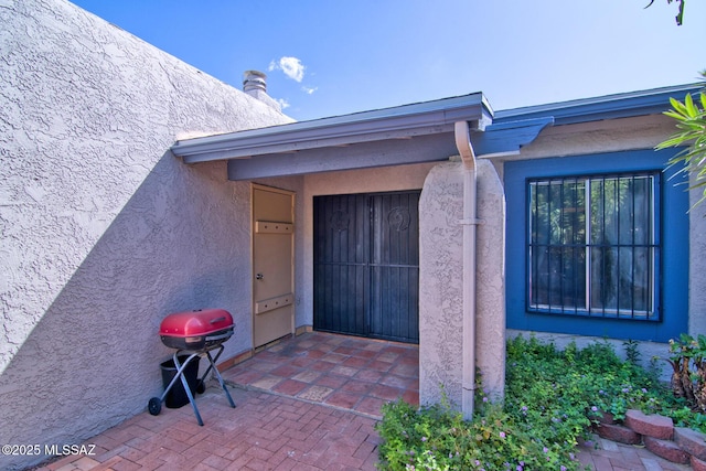 property entrance with stucco siding