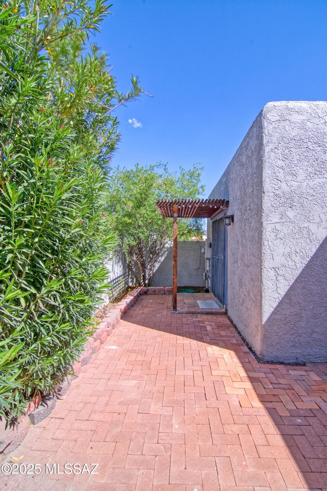 view of patio featuring fence