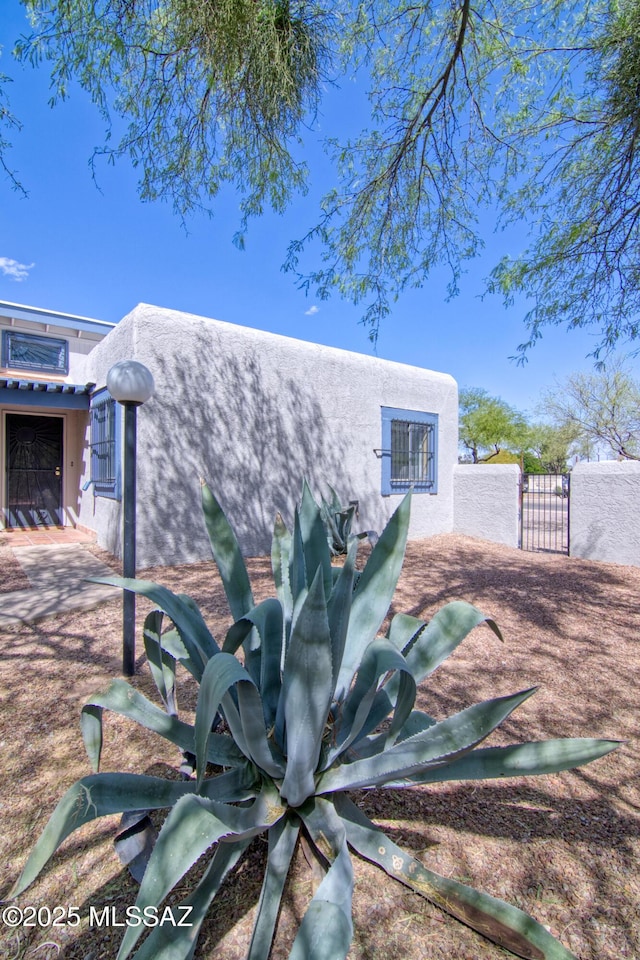 back of property with a gate