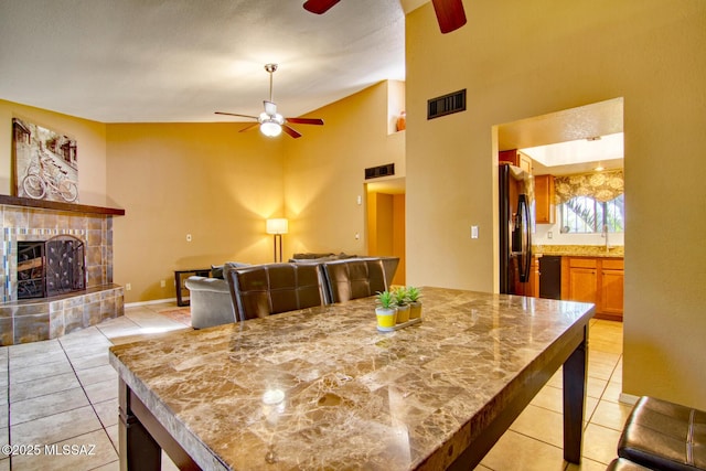 dining room featuring light tile patterned floors, visible vents, and a ceiling fan