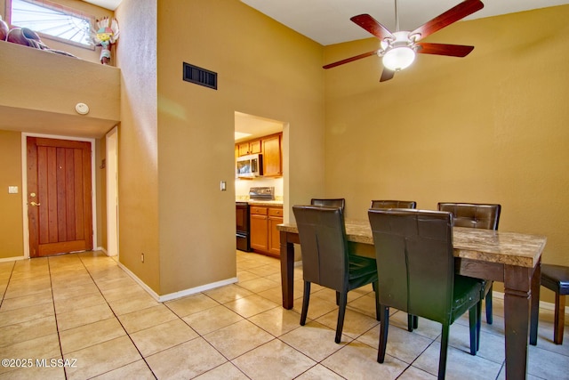 dining room featuring light tile patterned flooring, baseboards, visible vents, and a ceiling fan