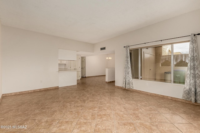 unfurnished living room featuring light tile patterned flooring, baseboards, and visible vents