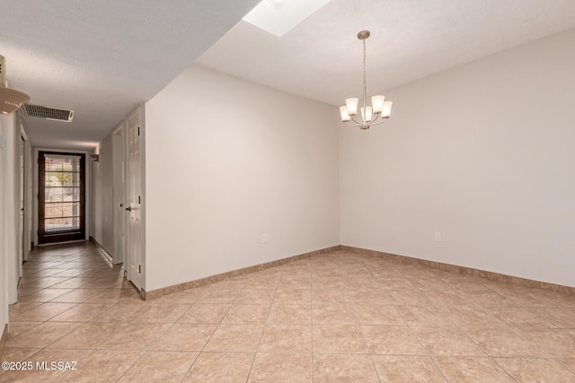 unfurnished room with baseboards, visible vents, light tile patterned floors, and a chandelier