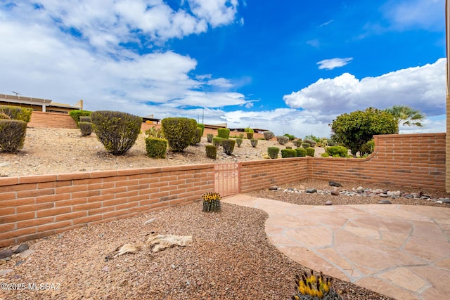 view of yard featuring fence and a patio