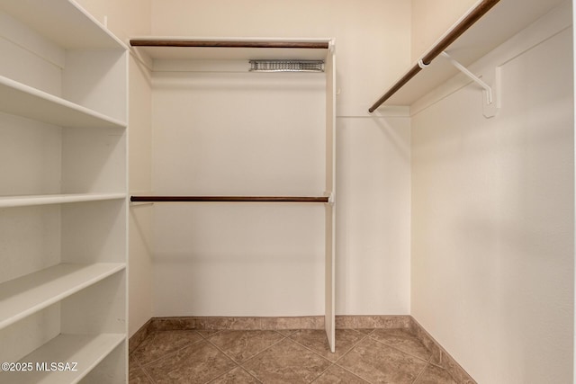 spacious closet with tile patterned floors