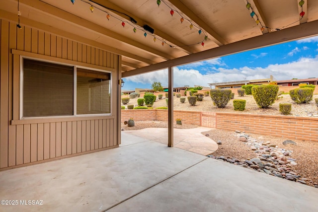 view of patio featuring fence