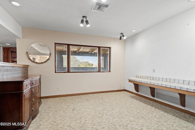 interior space with visible vents, baseboards, recessed lighting, and light carpet