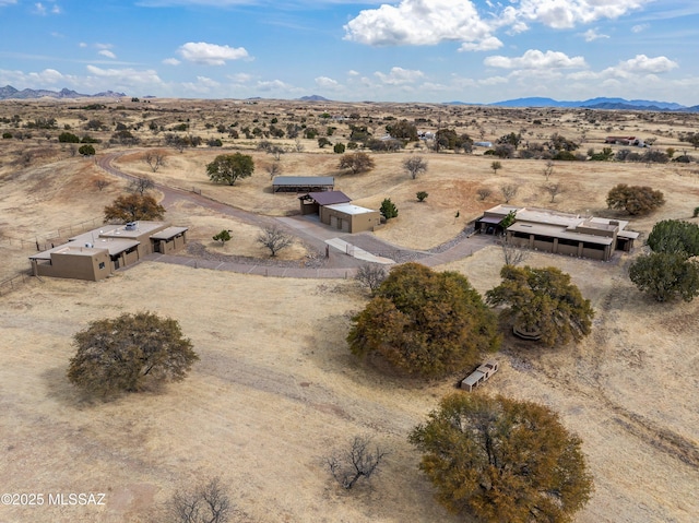 aerial view with a mountain view, a rural view, and a desert view