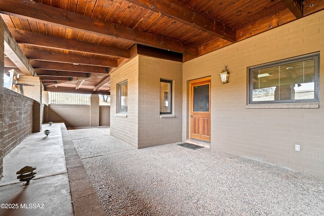 doorway to property with fence and brick siding
