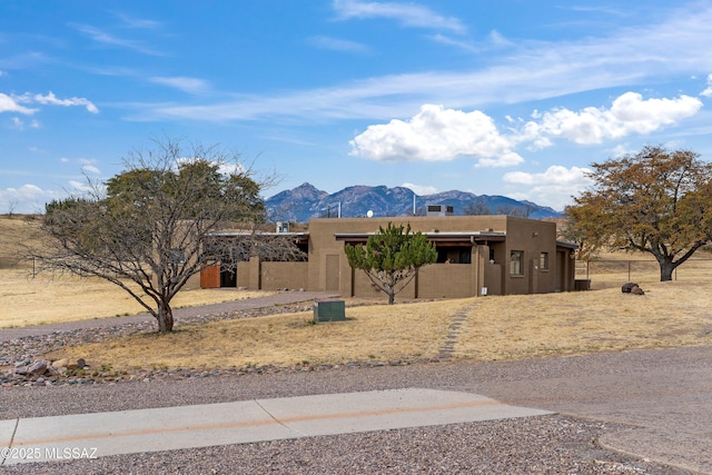southwest-style home with a mountain view and stucco siding