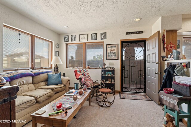 carpeted living area featuring recessed lighting and a textured ceiling
