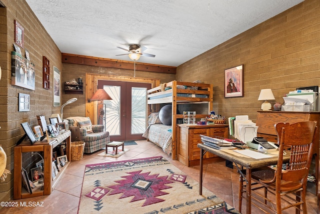 bedroom with light tile patterned floors, access to exterior, a textured ceiling, and french doors