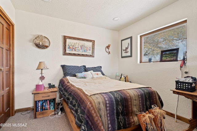 bedroom featuring carpet, a textured ceiling, and baseboards