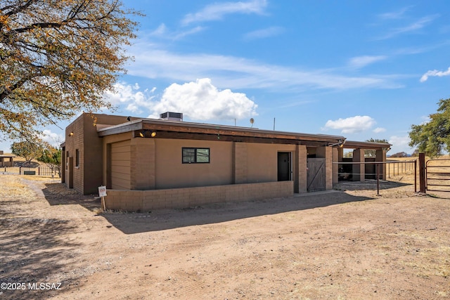 back of property featuring an outdoor structure and an exterior structure
