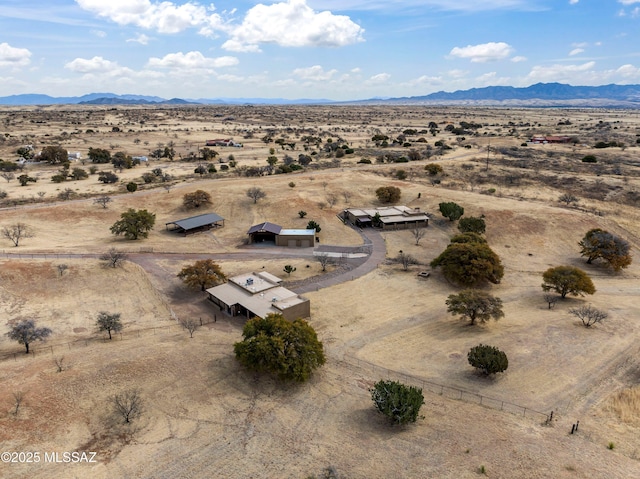 bird's eye view with a rural view, view of desert, and a mountain view