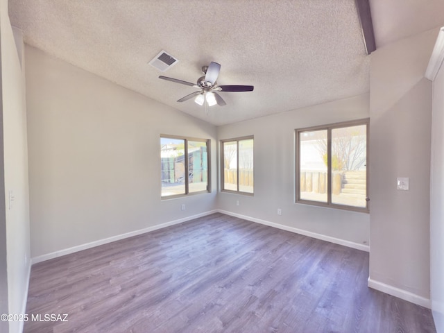 3438 Avenida Del Pueblo, Tucson, AZ 85746 - spare room featuring dark wood finished floors, plenty of natural light, and ceiling fan