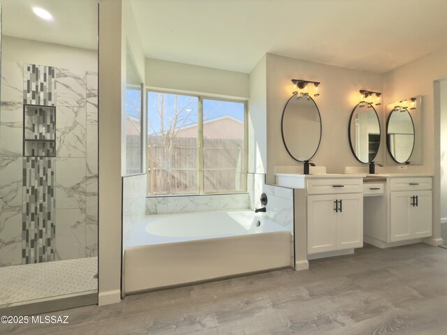 3438 Avenida Del Pueblo, Tucson, AZ 85746 - bathroom with wood finished floors, vanity, baseboards, walk in shower, and a garden tub