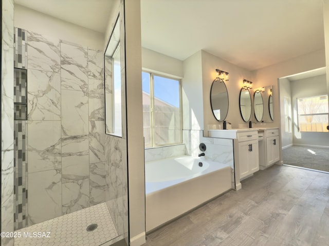 3438 Avenida Del Pueblo, Tucson, AZ 85746 - full bathroom featuring a garden tub, wood finished floors, vanity, baseboards, and a walk in shower