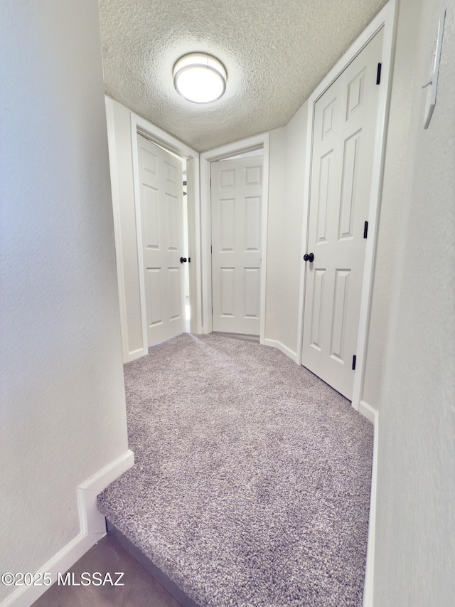 3438 Avenida Del Pueblo, Tucson, AZ 85746 - corridor with carpet floors, baseboards, and a textured ceiling