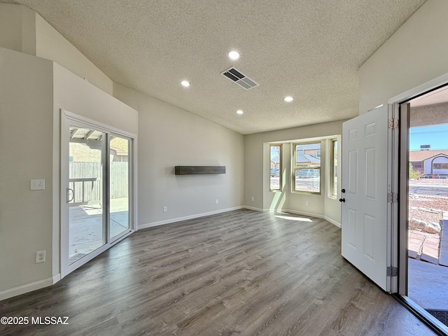 3438 Avenida Del Pueblo, Tucson, AZ 85746 - unfurnished living room featuring wood finished floors, a textured ceiling, visible vents, and recessed lighting
