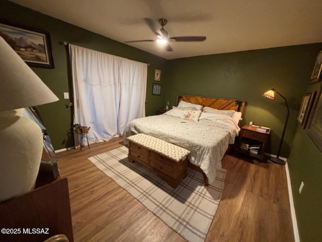 bedroom featuring wood finished floors, ceiling fan, and baseboards