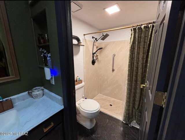 bathroom featuring toilet, a stall shower, and vanity