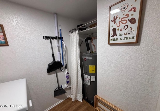 utility room featuring water heater