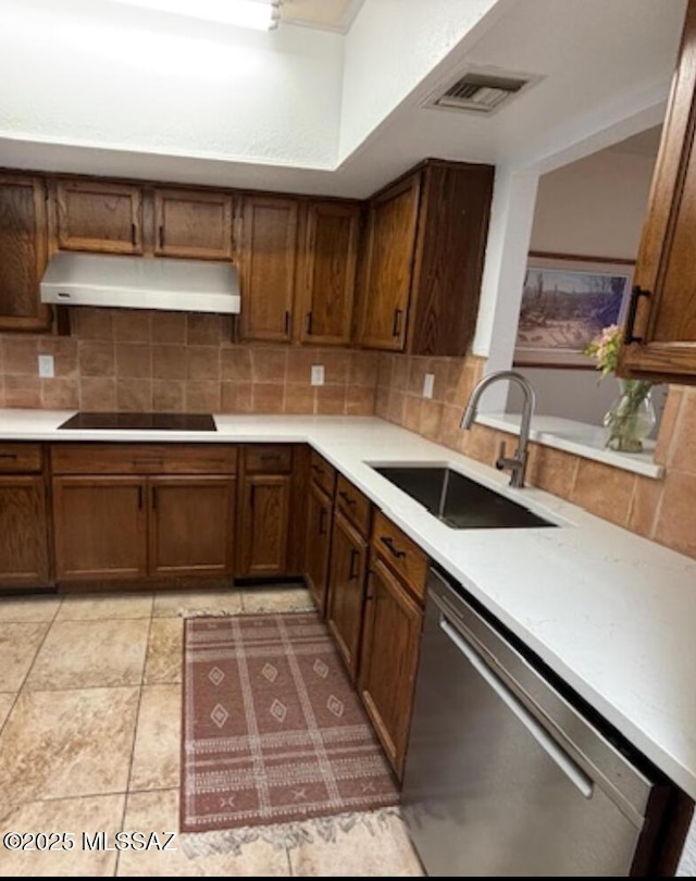 kitchen with light countertops, under cabinet range hood, black electric cooktop, dishwasher, and a sink