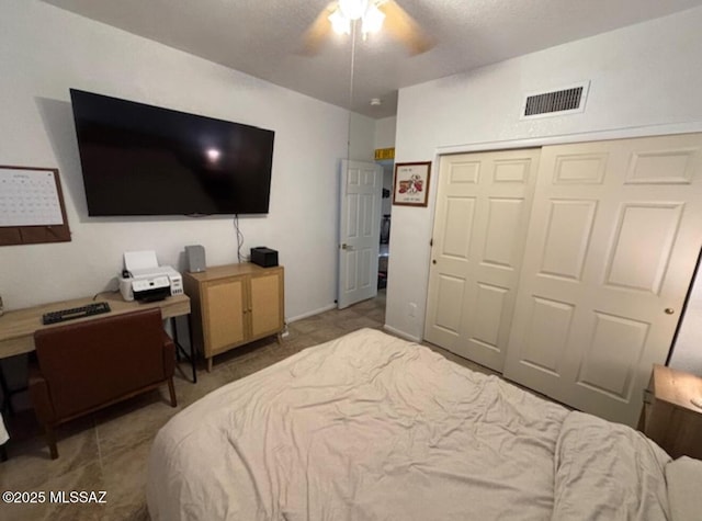 bedroom with visible vents, a closet, and ceiling fan