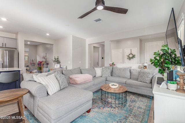 living area with visible vents, recessed lighting, and a ceiling fan