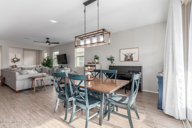 dining room featuring baseboards, visible vents, ceiling fan, and wood tiled floor