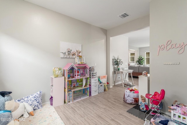 game room with wood finished floors and visible vents