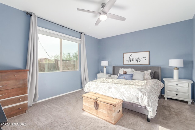 carpeted bedroom featuring baseboards and ceiling fan