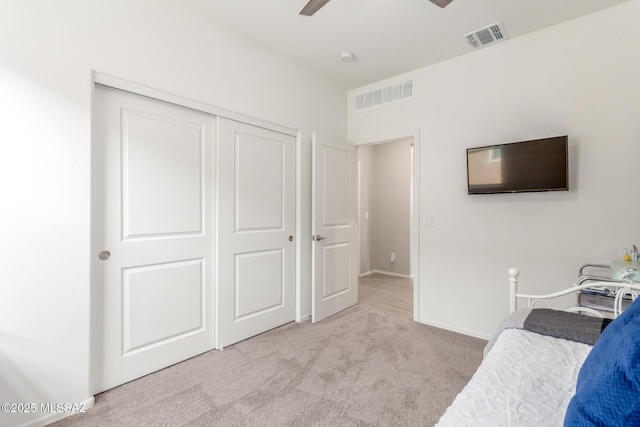 unfurnished bedroom featuring a closet, carpet flooring, visible vents, and a ceiling fan