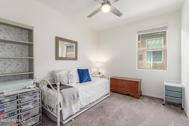 carpeted bedroom featuring baseboards and ceiling fan