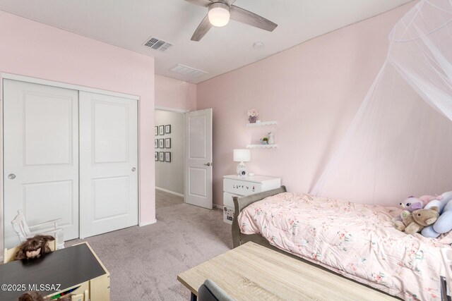 carpeted bedroom featuring a closet, ceiling fan, and visible vents