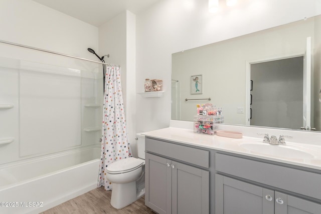 full bath with toilet, shower / bath combination with curtain, vanity, and wood finished floors