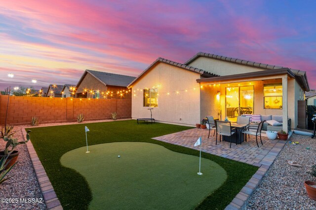 rear view of property with a patio, a fenced backyard, and stucco siding