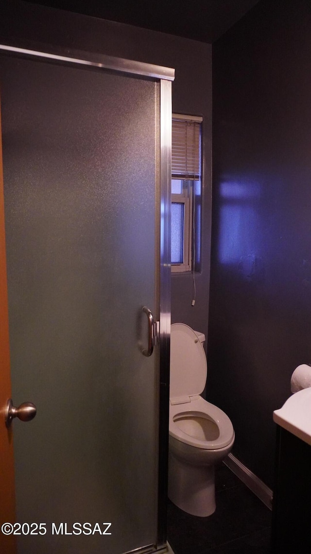 bathroom with toilet and a stall shower