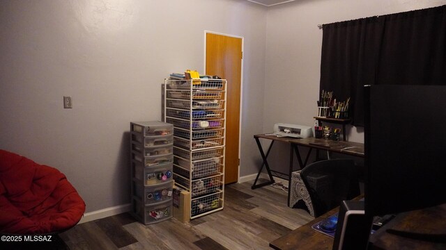 office space with baseboards and wood finished floors
