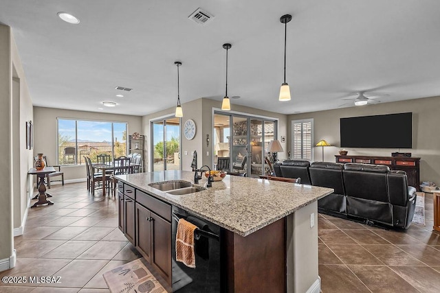 kitchen with decorative light fixtures, dark tile patterned flooring, a sink, visible vents, and black dishwasher