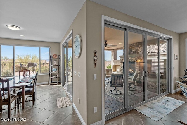 tiled dining area with baseboards and ceiling fan