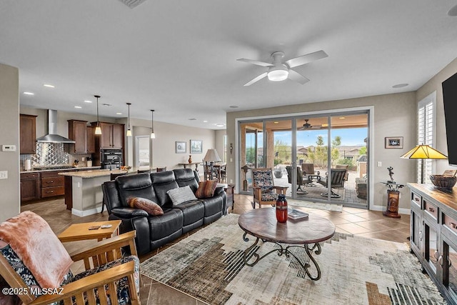 tiled living room featuring a ceiling fan, baseboards, and recessed lighting