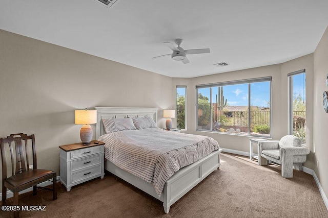bedroom with baseboards, dark colored carpet, ceiling fan, and visible vents