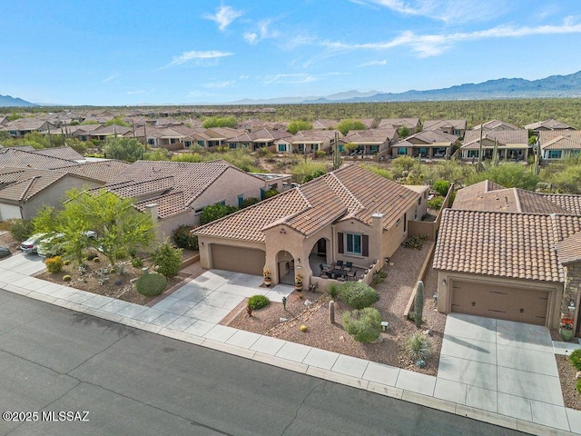 drone / aerial view with a mountain view and a residential view