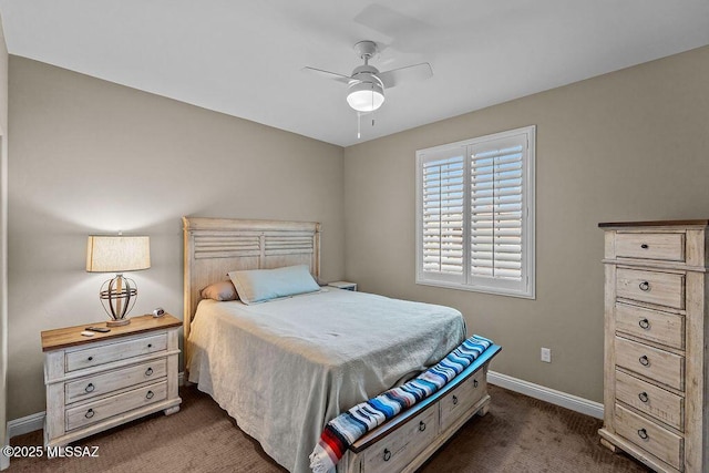 bedroom featuring baseboards and dark carpet