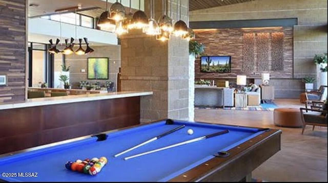 game room featuring a high ceiling, billiards, and a chandelier