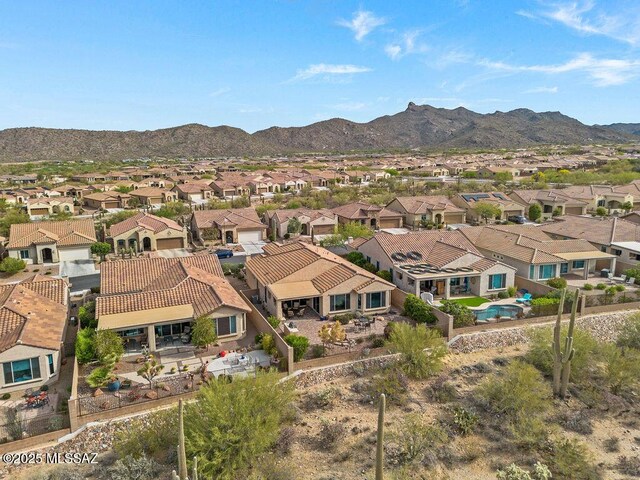 birds eye view of property with a mountain view and a residential view