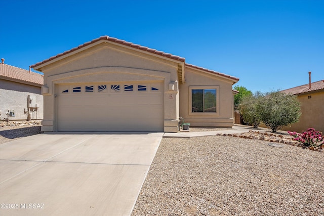 single story home featuring a tile roof, driveway, a garage, and stucco siding